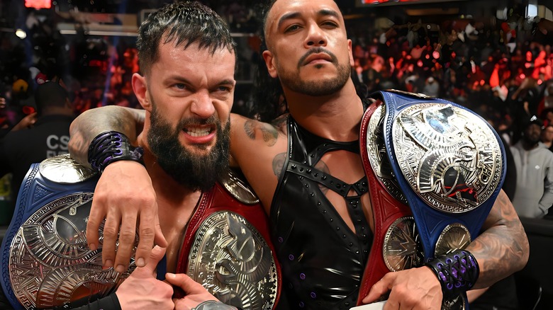 Finn Balor and Damian Priest pose with tag titles