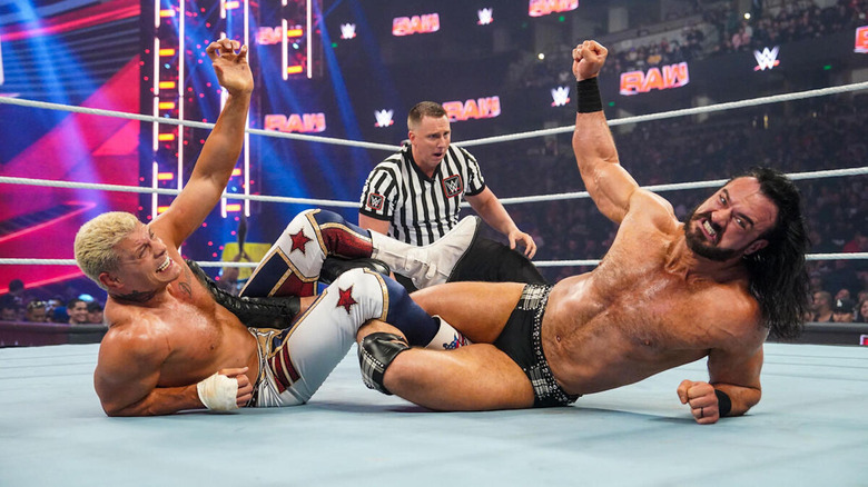 Cody Rhodes and Drew McIntyre struggle in a leglock