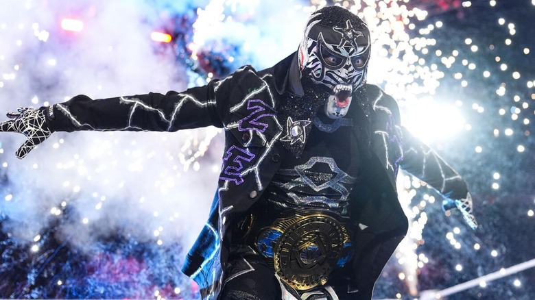 Intercontinental Champion Penta poses in the ring, his pyro going off behind him, before a match on 