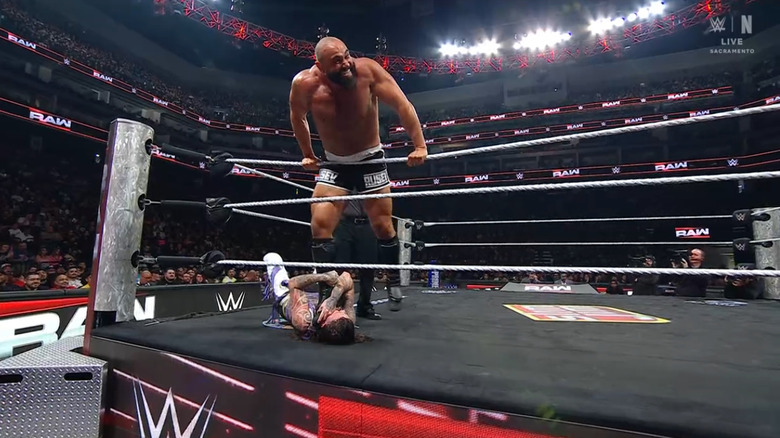 Rusev stomping on Dominik in the ring