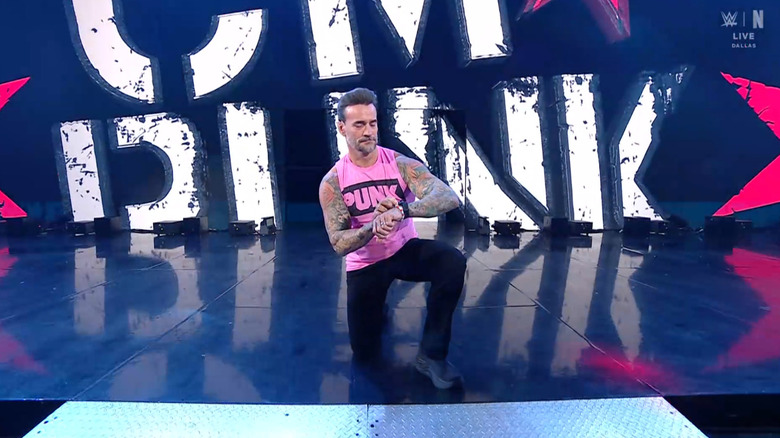Punk checking his watch on the entrance ramp
