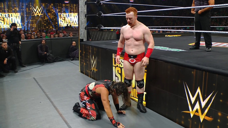 Sheamus standing over Nakamura on the outside