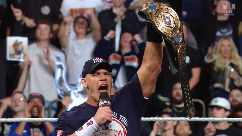 Cena holding up the Intercontinental Championship belt