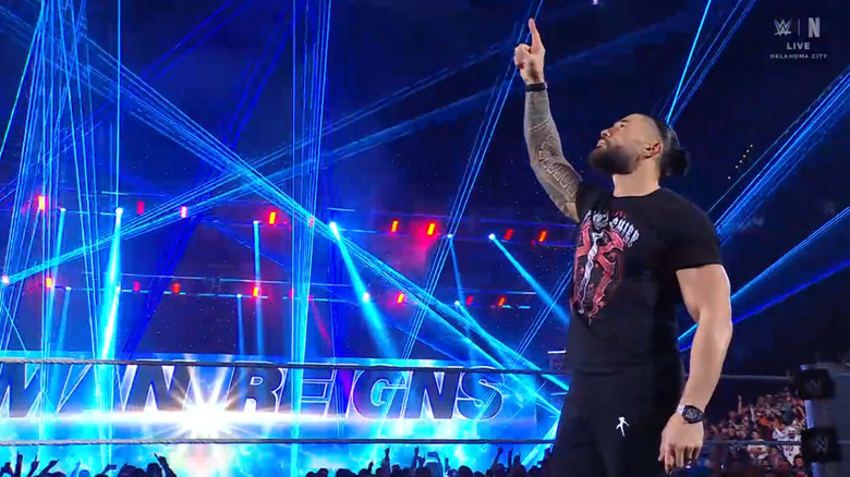 Reigns holding up the One symbol