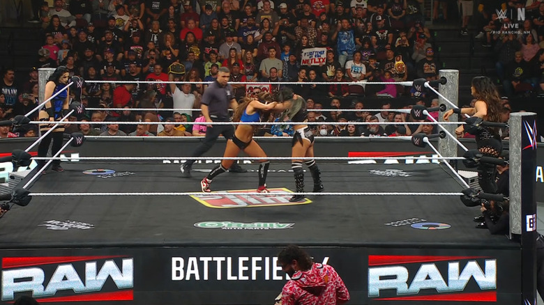 Nikki and Perez locking up as Vaquer and Rodriguez watch from the apron