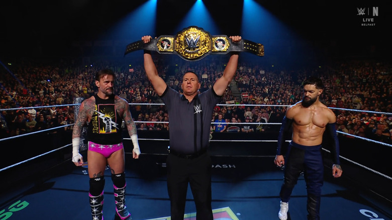 Punk and Balor staring one another down in the ring