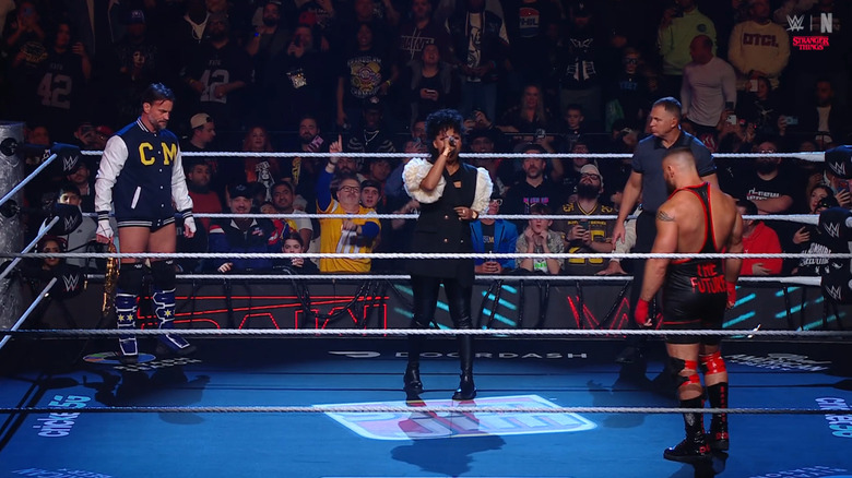 Punk and Breakker staring each other down during ring announcements