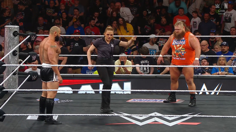 Rusev and Otis staring each other down in the ring