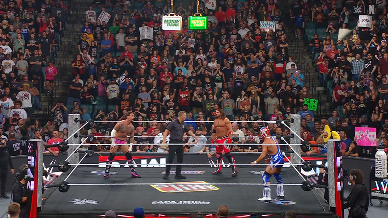 The three men in the ring about to lock up