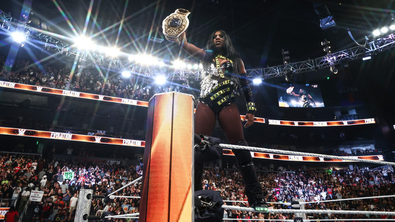 Naomi holding up the Women's World Championship