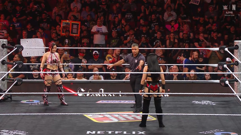 SKY and Vaquer staring one another in the ring