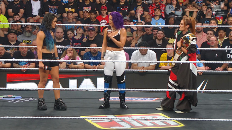 Valkyria, Bayley, and Lynch speaking to one another in the ring