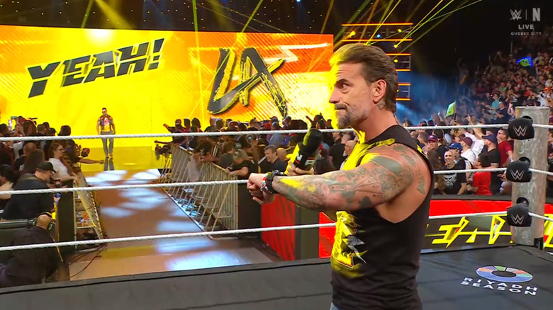 Knight coming to the ring as Punk stands inside