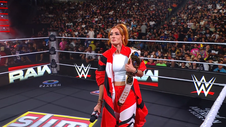 Lynch standing in the ring with her title
