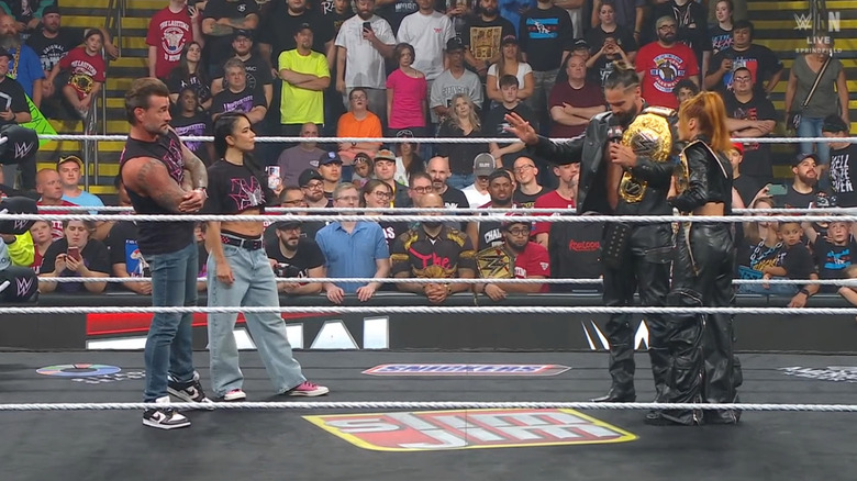 Punk, Lee, Rollins, and Lynch inside the ring