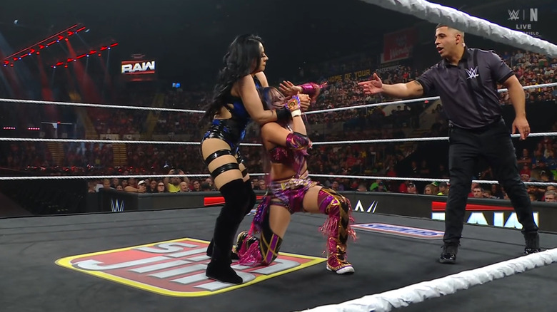 Vaquer wearing down Sane with a submission hold