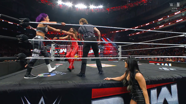 Bayley and Rodriguez in the ring as Perez watches on from the outside