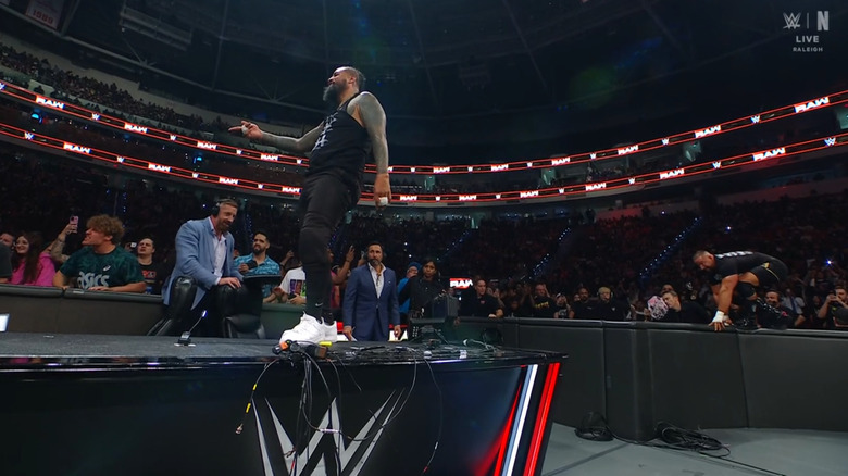 Breakker standing behind Jimmy on the outside