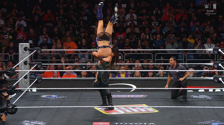 Rodriguez setting up for a delayed vertical suplex on Valkyria