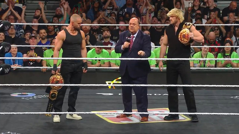 Paul Heyman with Logan Paul and Austin Theory in the ring