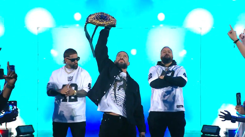 Roman Reigns enters with the Usos