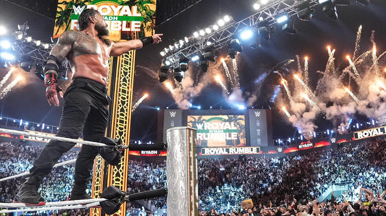 Roman Reigns pointing at WrestleMania sign after winning the Royal Rumble