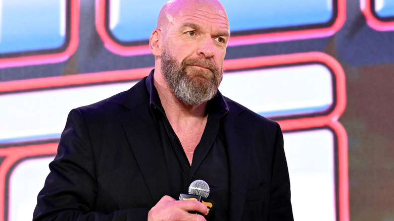 Paul Levesque with a microphone