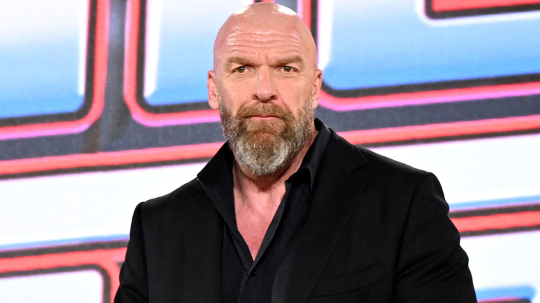 Triple H holding a microphone