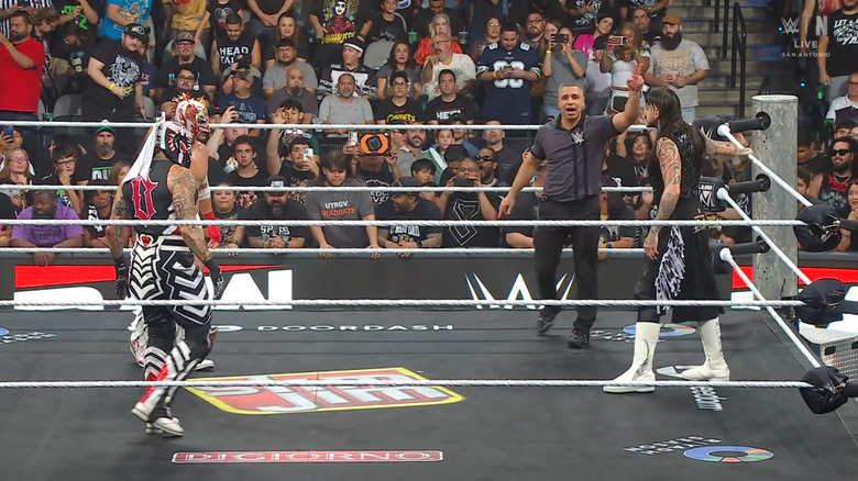 All three men inside the ring