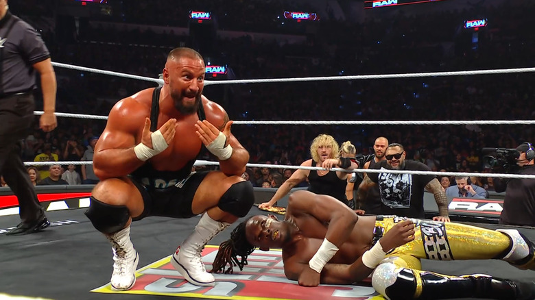 Breakker kneeling next to Evans