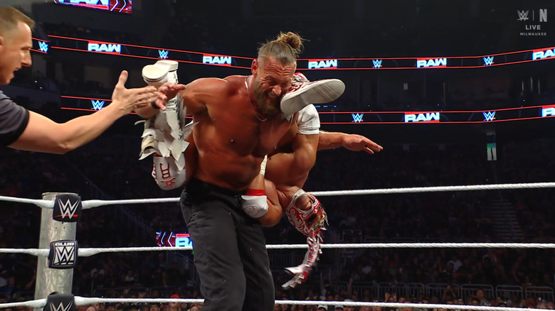 Lee with Cass tangled up in a submission hold