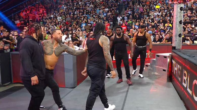 The Bloodline and The 946 in the ringside area about to brawl with one another