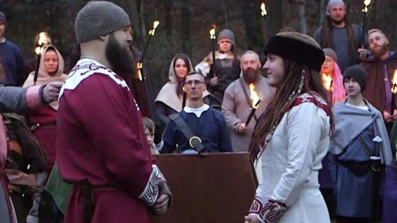 The War Raiders' Erik stands across from Sarah Logan during their Viking wedding ceremony.