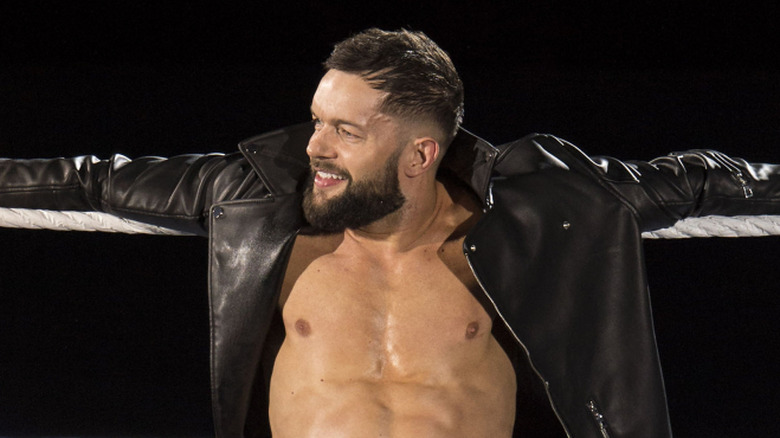 Finn Balor hanging from the ropes