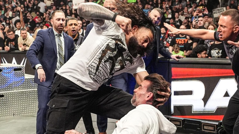 Roman Reigns punches CM Punk
