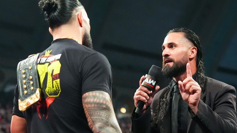 Seth Rollins confronts World Heavyweight Champion Roman Reigns in the ring to challenge him to a title match at SummerSlam during an episode of 