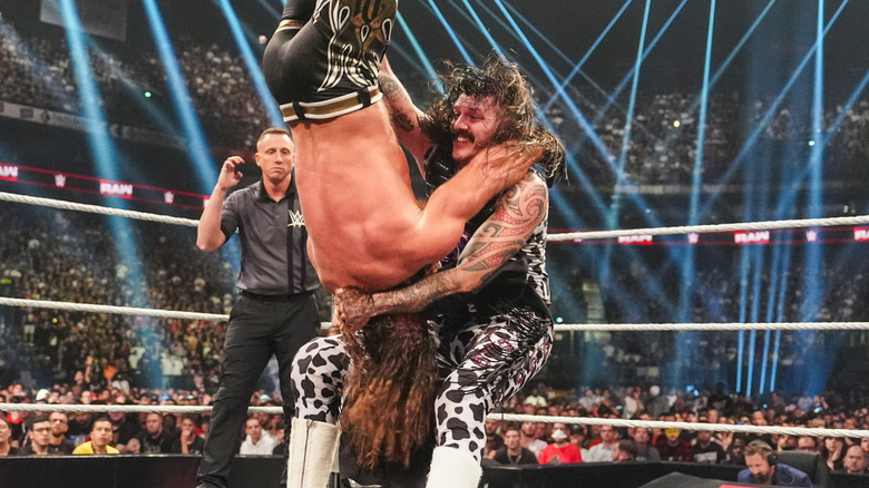 Dominik Mysterio hits AJ Styles with a Michinoku Driver
