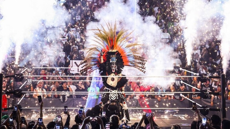 Penta poses in his elaborate ring gear, pyro going off behind him, ahead of his World Heavyweight Championship main event match against Roman Reigns on the September 14, 2026 edition of 