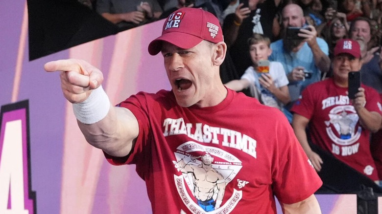 John Cena points to the crowd during his entrance on an episode of "WWE Raw."