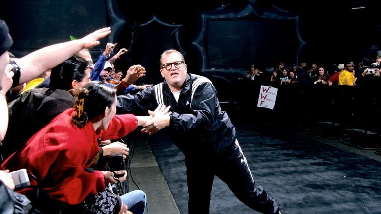 Drew Carey slaps hands with fans at WWE Royal Rumble 2001