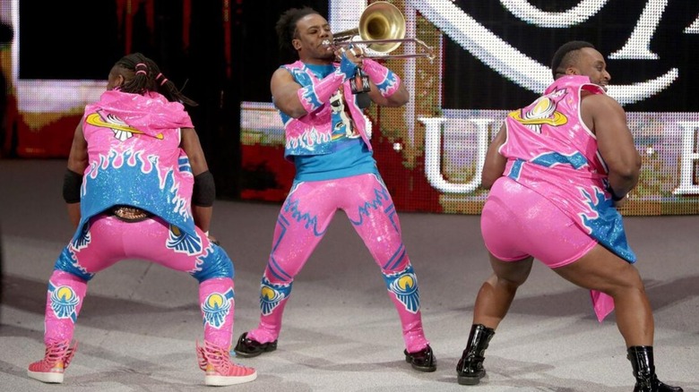 Xavier Woods plays the trombone while Kofi Kingston and Big E twerk on the stage before their WWE Tag Team Championship match against The Usos at the Royal Rumble 2016.