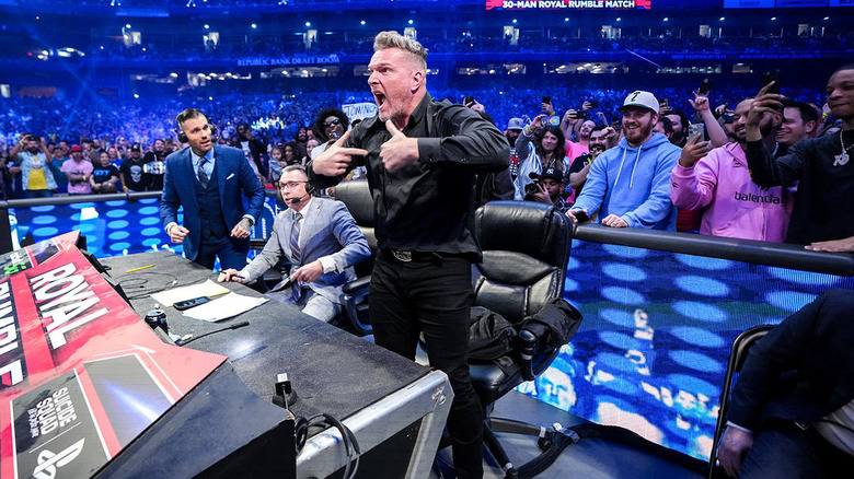 Pat McAfee standing up behind a desk