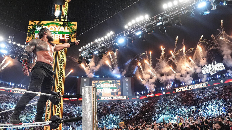 Roman Reigns points to the WrestleMania sign while fireworks go off at WWE Royal Rumble 2026