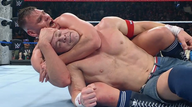 John Cena smiles before tapping out to Gunther's Rear Naked Choke