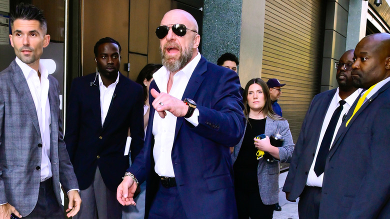 Triple H shouting in sunglasses