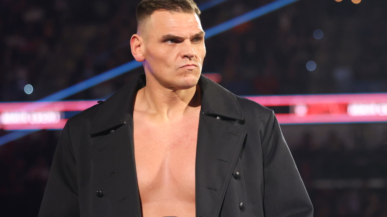 Gunther wearing a black ring coat