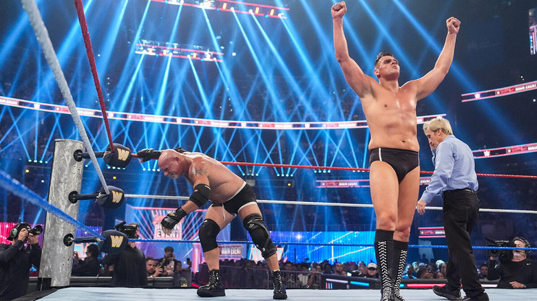 GUNTHER stands with his arms raised in front of Goldberg at "WWE Saturday Night's Main Event"