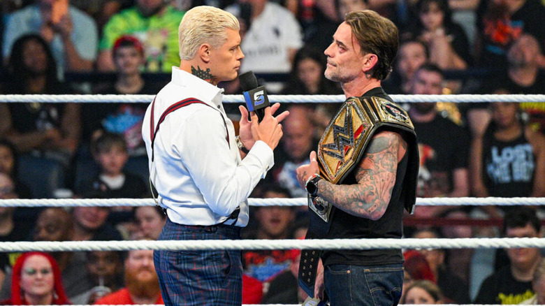 Cody Rhodes and CM Punk looking at each other