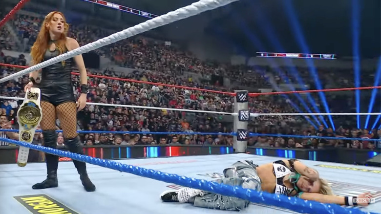 Lynch standing over Ruca in the ring