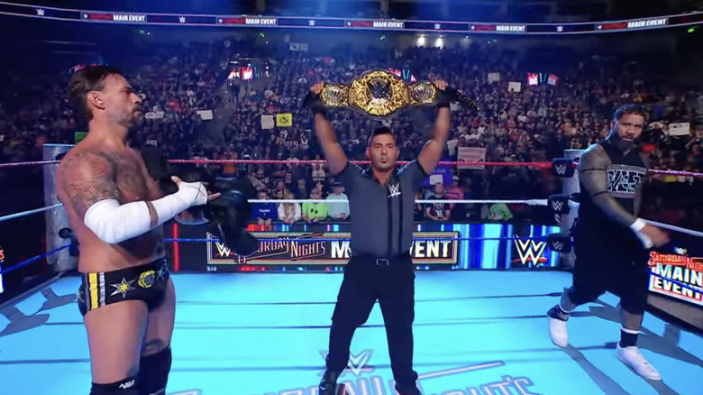 Punk and Jey staring one another down in the ring